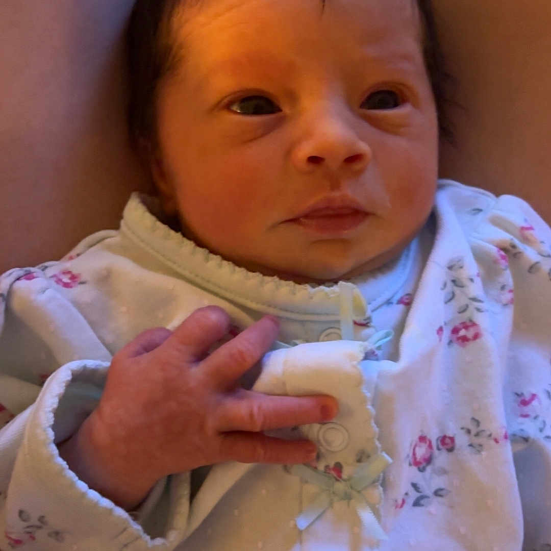 Amané is registered to the contest to win money with this photo: baby, blanket, bodypart, bonnet, clothing, couch, cushion, face, finger, furniture, hand, hat, head, knitwear, newborn, person, photography, portrait, sweater, towel