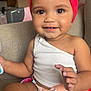 baby, bright, casual_clothing, child, colorful_skirt, couch, curly_hair, cute, face, hands, happy, indoor, playful, portrait, red_headband, sitting, skin, smiling, toddler, white_top