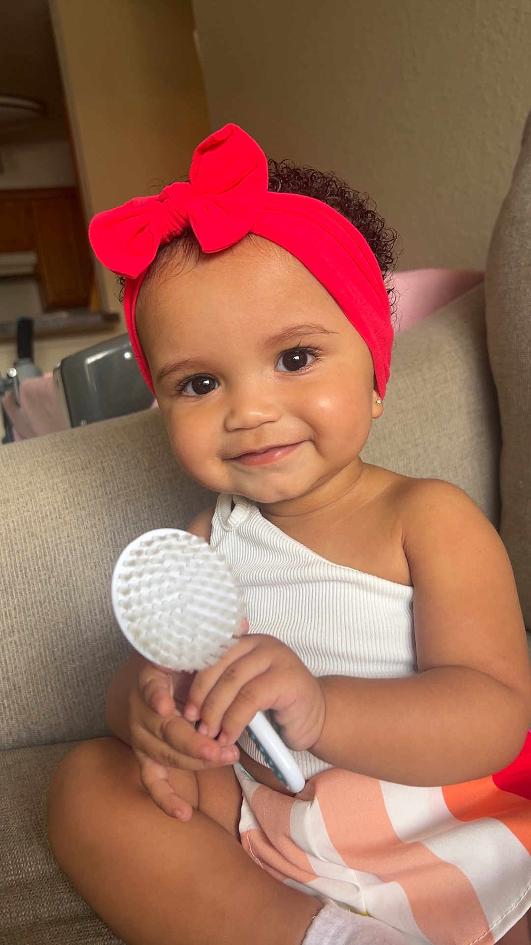Zilyncia joined the competition — help win amazing prizes! baby, brush, child, couch, curly_hair, cute, earrings, face, hand, happy, headband, indoor, portrait, red_bow, sitting, skin, smiling, striped_skirt, toddler, white_top