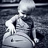ball, baller, basketball, black_and_white, casual_clothing, child, curious, daylight, grass, monochrome, nature, nike, outdoor, playing, portrait, short_hair, single_child, sports_equipment, toddler, young_child