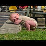 Gunner is registered to the contest to win money with this photo: arms, baby, beige_clothing, child, concrete, crouching, cute, daylight, furniture, garden, grass, head, leaning, nature, outdoor, peaceful, portrait, resting, sunlight, yard