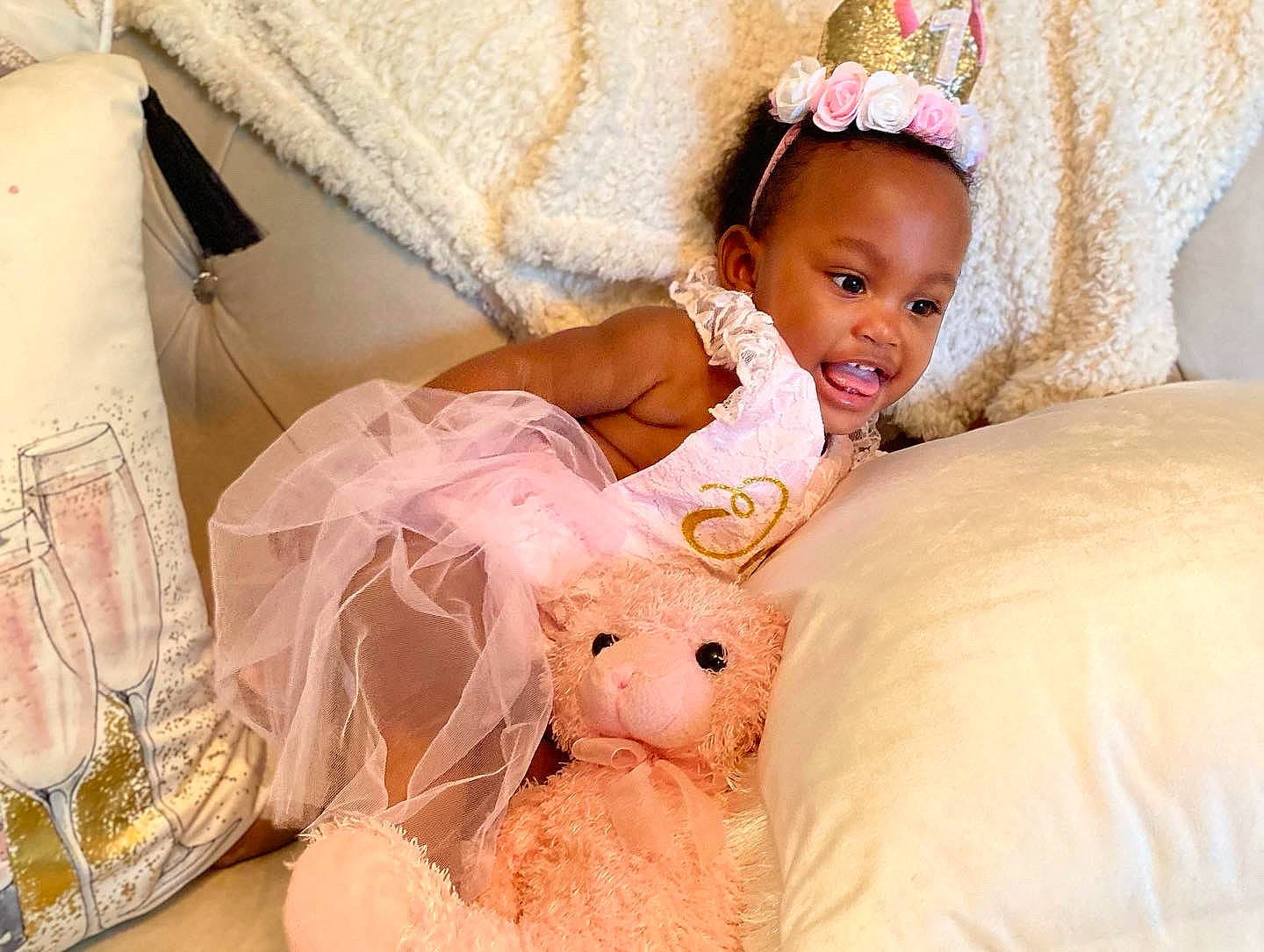 Adeline is registered to the contest to win money with this photo: baby, baby_toddler_clothing, bed, bedding, bridal_accessory, comfort, dress, event, fashion_accessory, happy, headband, headpiece, linens, peach, person, pink, skin, smile, textile, toddler