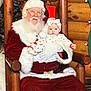 baby, santa, child, infant, beard, hat, red_clothing, holiday, christmas, chair, log_cabin, wood_paneling, glasses, costume, portrait, seat, cute, festive, unimpressed, smile