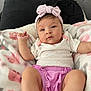 Emma Peña Bello joined the competition — help win amazing prizes! baby, infant, headband, pink, blanket, soft, cute, clothing, lying_down, indoors, person, child, face, expression, legs, arm, couch, comfort, young, portrait