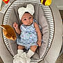 baby, infant, child, baby_seat, headband, bow, socks, plush_toy, bee_toy, bear_toy, clothing, carpet, indoor, cute, portrait, smiling, person, baby_girl, soft_toys, comfortable