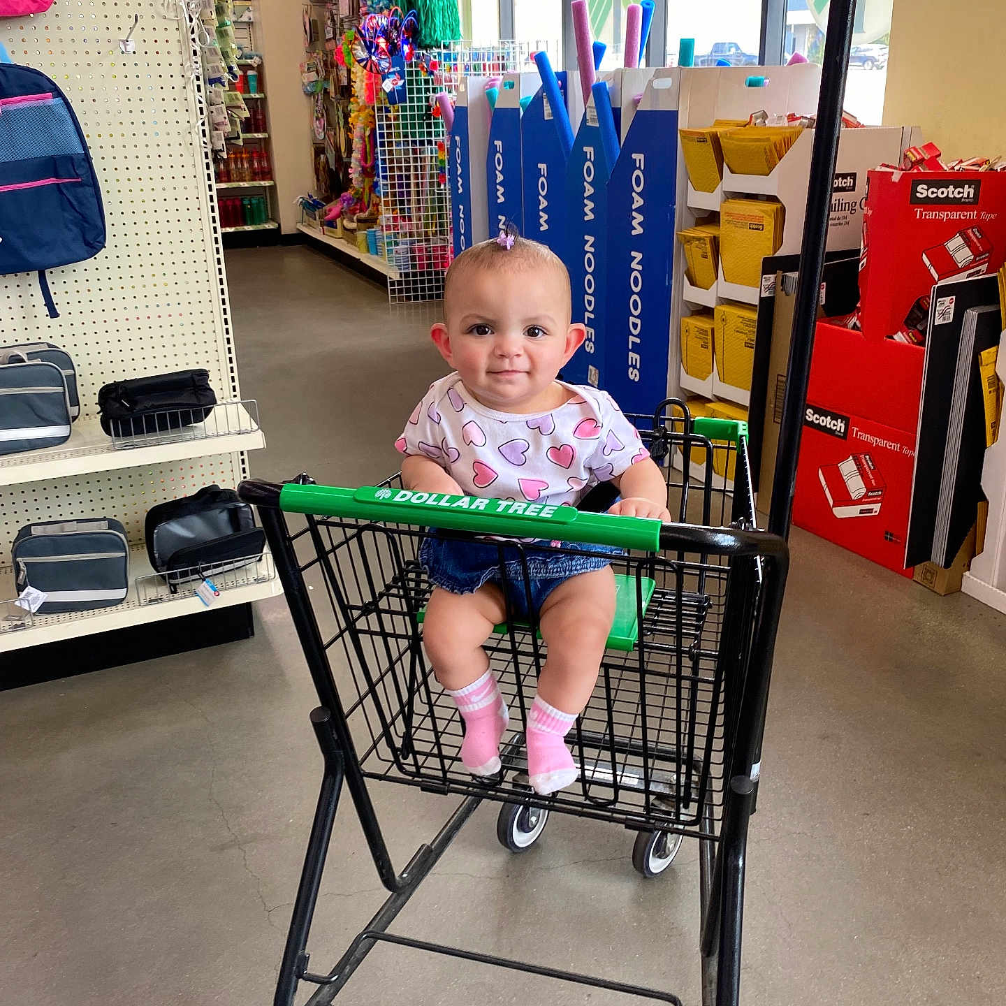Zoella Grace is registered to the contest to win money with this photo: aisle, baby, baby_clothing, child, cute, floor, foam_noodles, heart_shirt, indoor, packaging, person, pink_socks, product_display, retail, shopping, shopping_cart, smile, store_interior, toy, window
