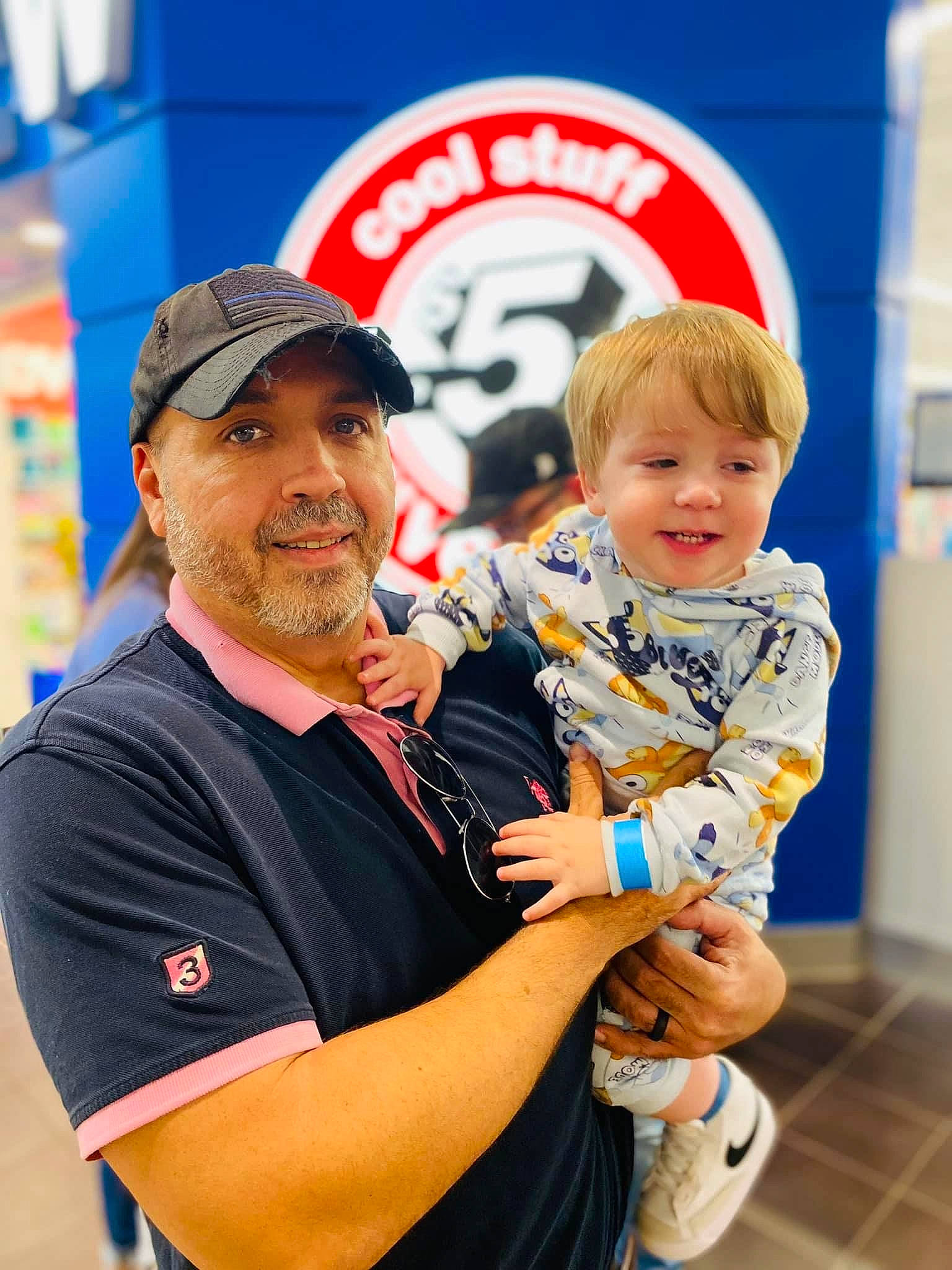 Titus is registered to the contest to win money with this photo: baby, baseball_cap, belt, cap, child, elbow, electric_blue, event, fun, gesture, happy, hat, headwear, joy, leisure, logo, person, recreation, smile, t_shirt