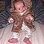Arlo joined the competition — help win amazing prizes! baby, infant, coat, brown_coat, pajamas, bed, blanket, feet, hands, face, red_eye, sitting, indoor, striped_bedspread, soft_texture, curious_expression, clothing, cute, newborn, child