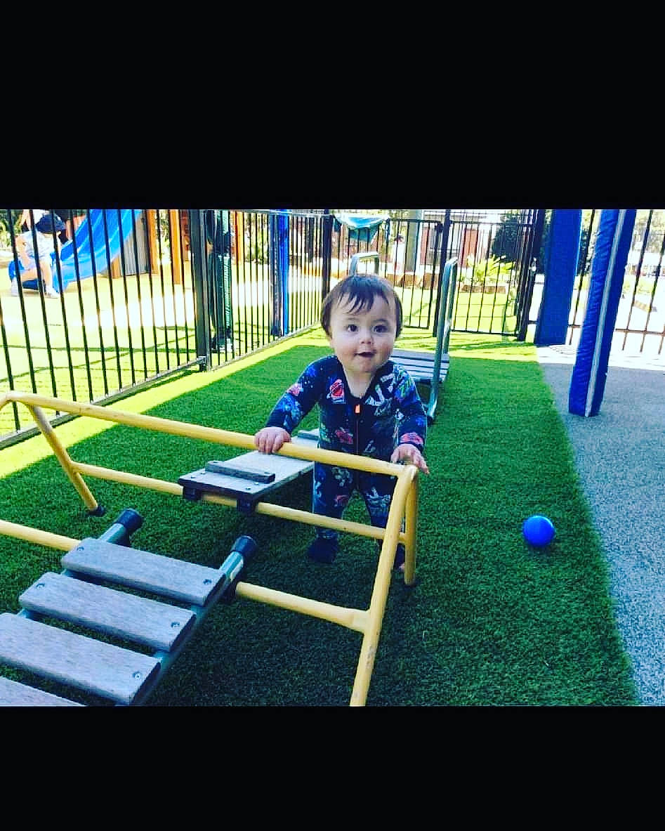 Malik joined the competition — help win amazing prizes! baby, child, city, electric_blue, flooring, fun, grass, human_settlement, leisure, outdoor_play_equipment, outdoor_recreation, person, play, playground, playground_slide, recreation, sitting, swing, symmetry, t_shirt