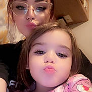 Camari Jo is registered to the contest to win money with this photo: woman, child, glasses, pink_clothing, nose_ring, indoor, selfie, puckered_lips, portrait, face, person, young_child, casual, happy, cute, family, closeup, expression, warm_lighting, cozy