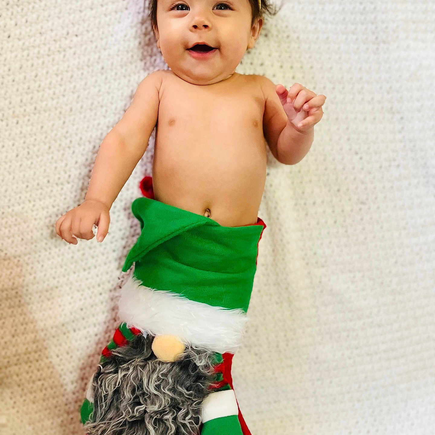Ivy is registered to the contest to win money with this photo: accessories, baby, bodypart, christmas, christmasdecorations, christmasstocking, clothing, dress, face, festival, finger, gift, glove, hand, head, hosiery, person, photography, portrait, stocking
