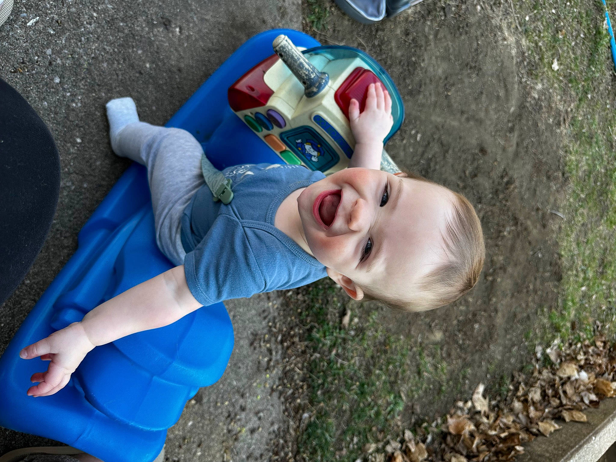 Ace is registered to the contest to win money with this photo: adventure, asphalt, auto_part, blue, electric_blue, eyewear, fun, grass, happy, human_leg, leisure, people_in_nature, person, play, recreation, smile, soil, summer, t_shirt, toddler