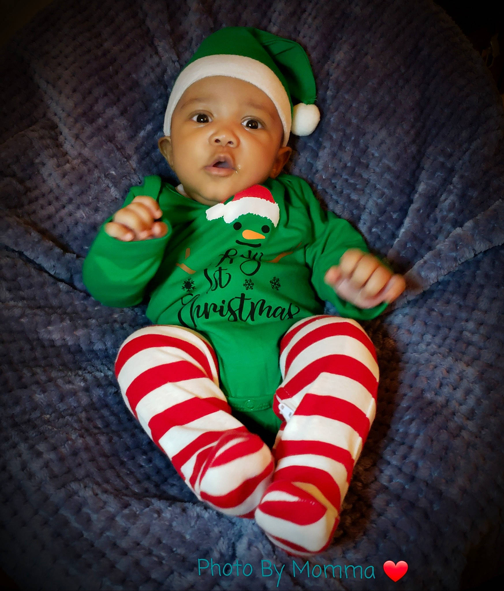 Amari is registered to the contest to win money with this photo: baby, baby_products, baby_toddler_clothing, baby_toys, child, comfort, costume_accessory, headwear, human_body, nose, person, sleeve, sock, toddler