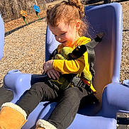 Harmani joined the competition — help win amazing prizes! boots, casual, child, curly_hair, daylight, happy, nature, outdoor, park, play_equipment, playground, seatbelt, smiling, stuffed_animal, swing, toy, trees, winter_clothing, yellow_clothing, young_child