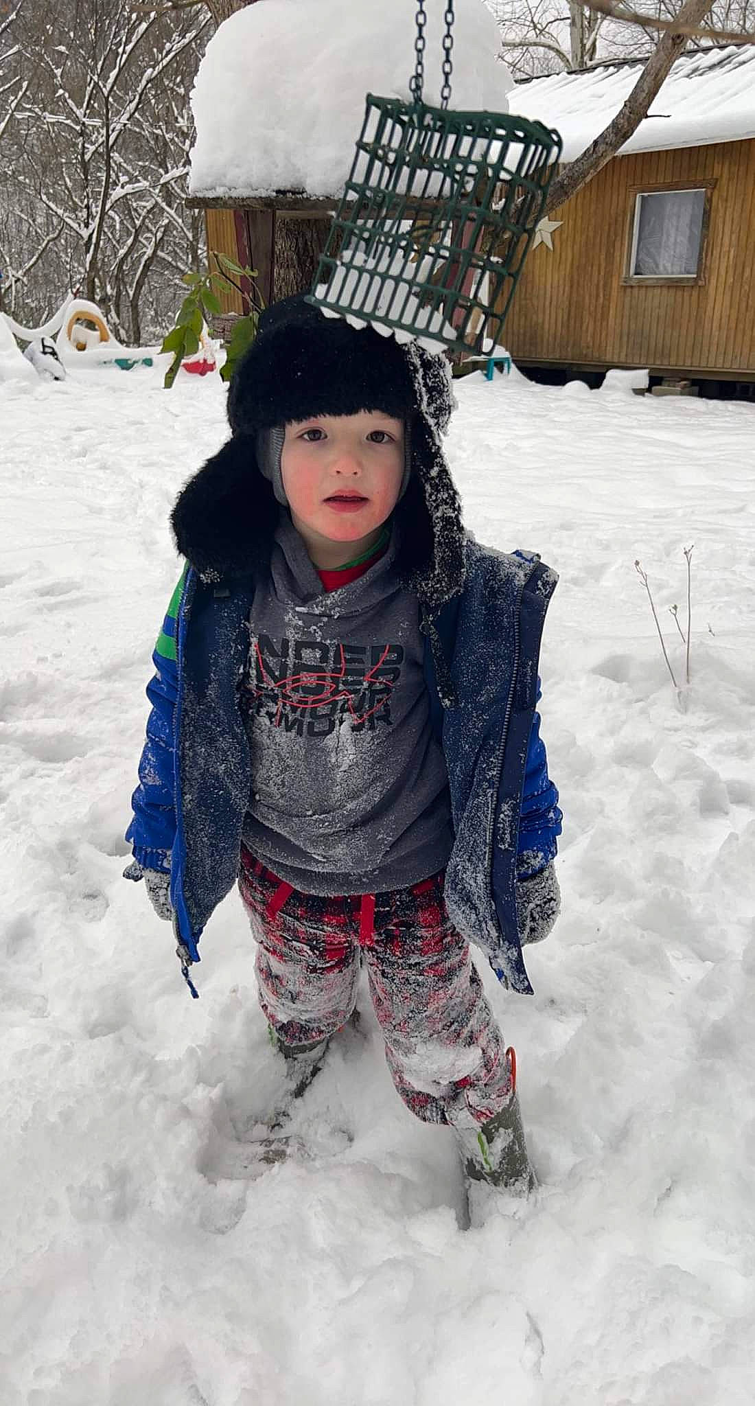 Easton is registered to the contest to win money with this photo: baby, beanie, child, event, freezing, fun, fur, happy, headgear, headwear, hoodie, pattern, person, play, playing_in_the_snow, precipitation, sitting, snow, street_fashion, toddler