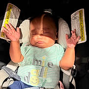 Kam is registered to the contest to win money with this photo: baby, sleeping, car_seat, shirt, striped_clothing, pacifier, shadow, hand, infant, child, seatbelt, pink_blanket, safety, closed_eyes, cute, adorable, expression, indoors, peaceful, strap