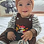 Emiliano is registered to the contest to win money with this photo: baby, child, smiling, hat, striped_clothing, brown_outfit, knitted_toy, elephant_toy, bed, blanket, cozy, indoor, cute, happy, portrait, sitting, hands, socks, toy, infant