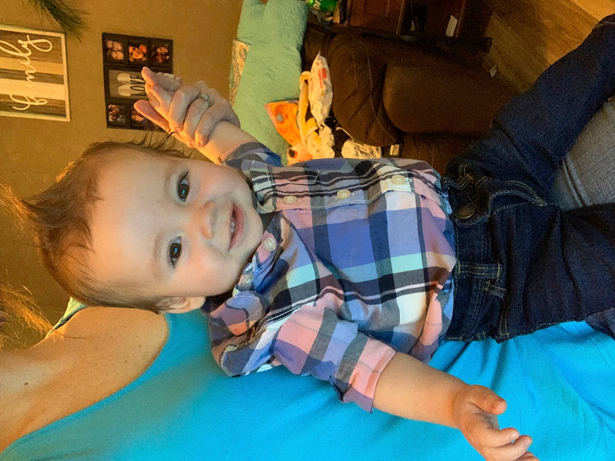 Madden is registered to the contest to win money with this photo: baby, cheek, chest, child, comfort, electric_blue, finger, fun, happy, joy, leisure, mouth, party, pattern, person, plaid, room, sitting, smile, tartan