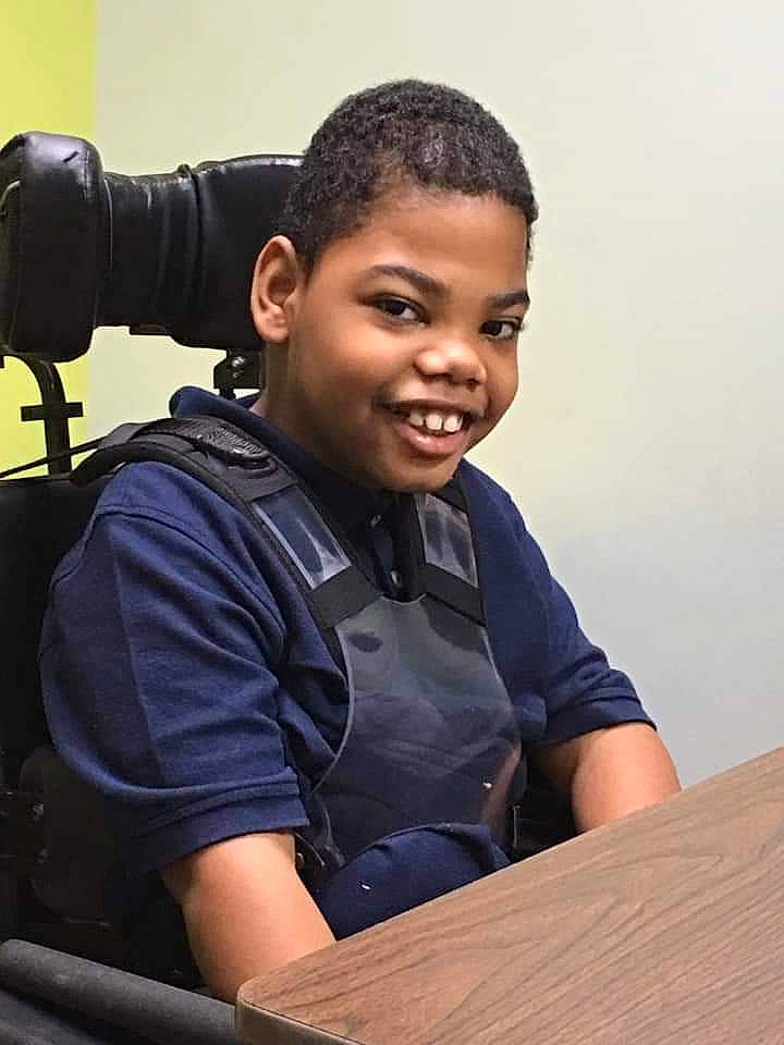 Zephaniah is registered to the contest to win money with this photo: child, job, joy, person, sitting, student