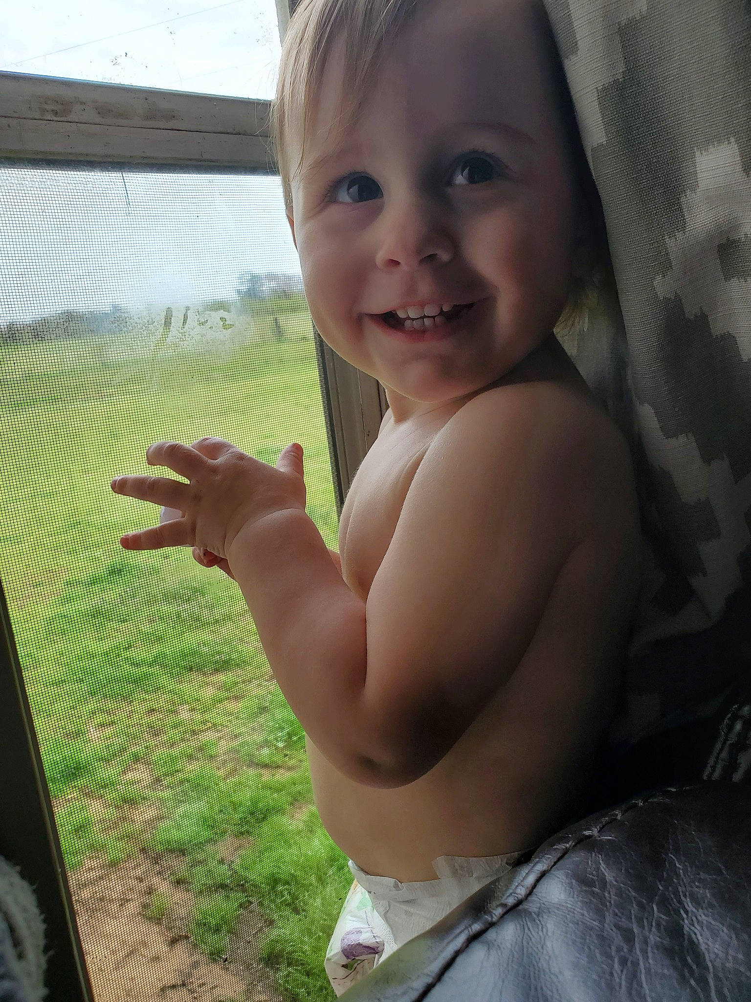 Landry is registered to the contest to win money with this photo: arm, cheek, child, eye, face, facial_expression, finger, grass, hand, happy, head, joy, muscle, nose, person, skin, smile, summer, thumb, toddler