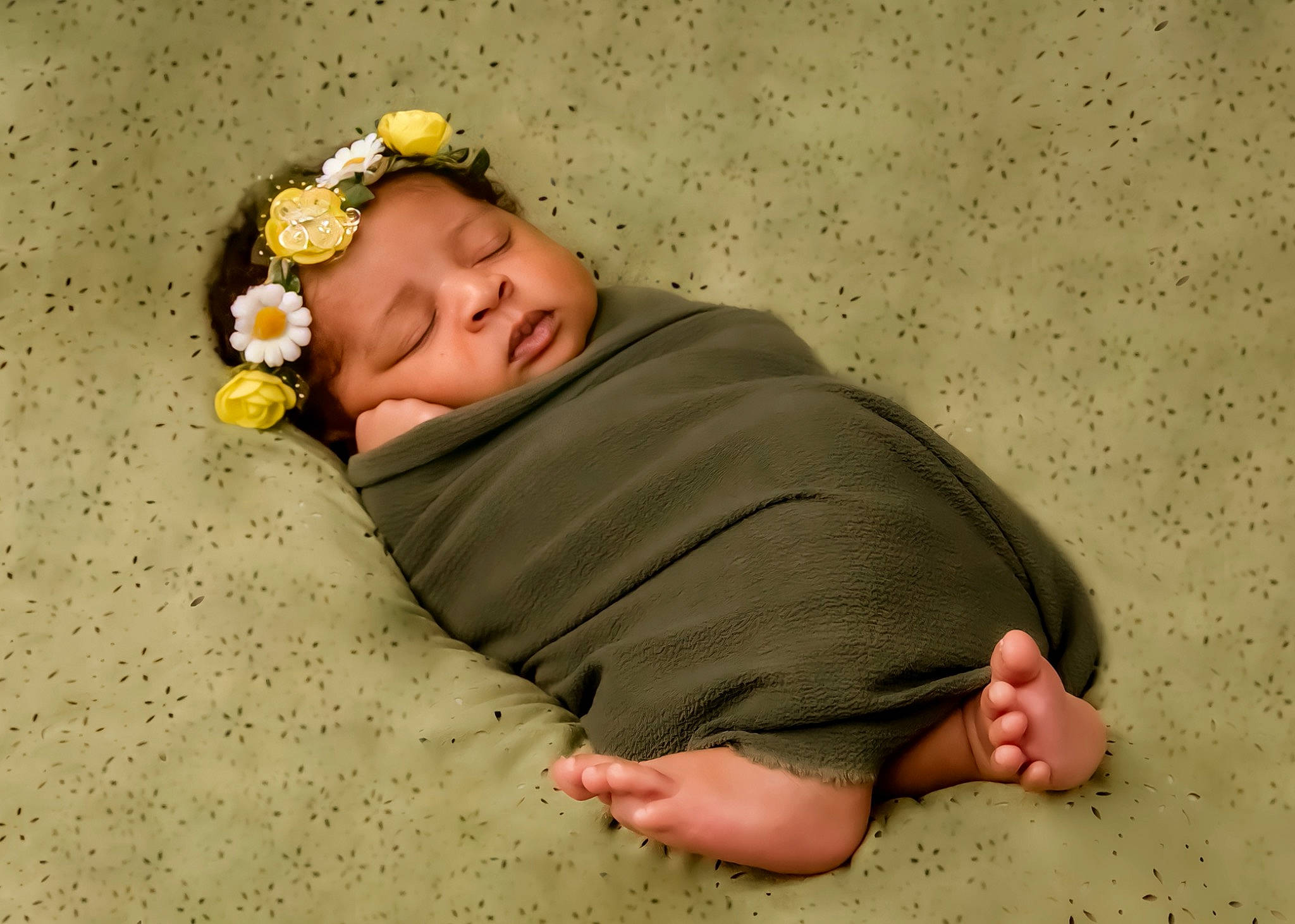 Aliah is registered to the contest to win money with this photo: arm, baby, baby_sleeping, barefoot, child, comfort, finger, flower, foot, fun, gesture, grass, happy, headpiece, linens, pattern, person, sand, sitting, sleeve