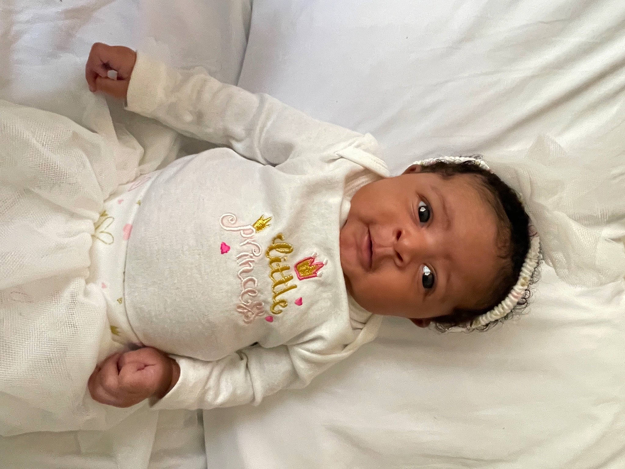 Aliah is registered to the contest to win money with this photo: baby, baby_products, baby_toddler_clothing, cheek, child, comfort, elbow, hand, happy, human_body, linens, mammal, nose, people, person, room, skin, sleeve, smile, textile