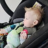 baby, child, car_seat, plush_toy, pacifier, bottle, spiky_hair, infant, seatbelt, candid, side_profile, indoor, cute, young_child, comfort, toy, clothing, person, portrait, baby_bottle
