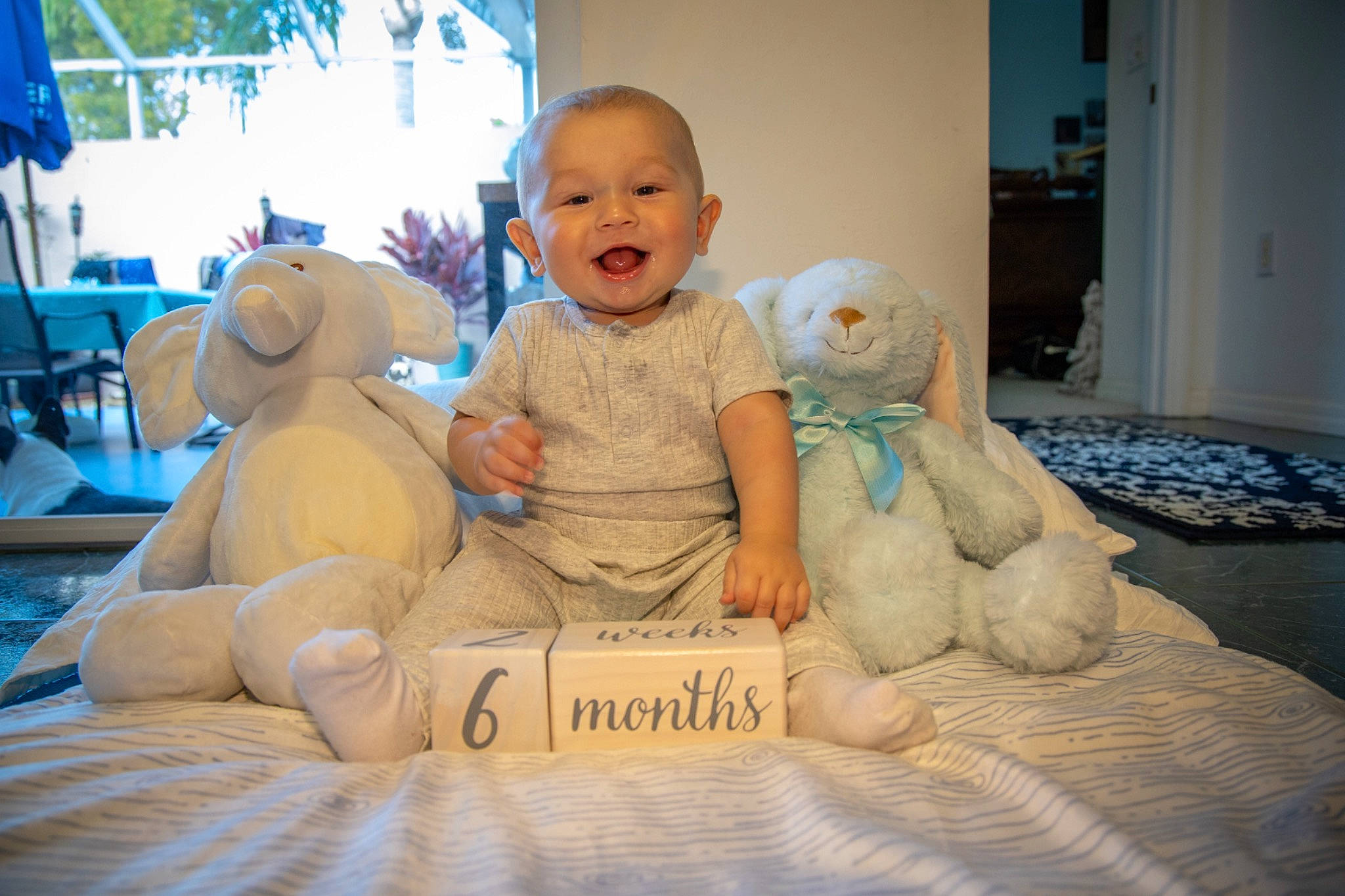 Arion joined the competition — help win amazing prizes! baby, blue, comfort, flooring, fun, happy, hat, leisure, linens, mammal, person, room, sitting, skin, smile, stuffed_toy, teddy_bear, toddler, toy, vertebrate