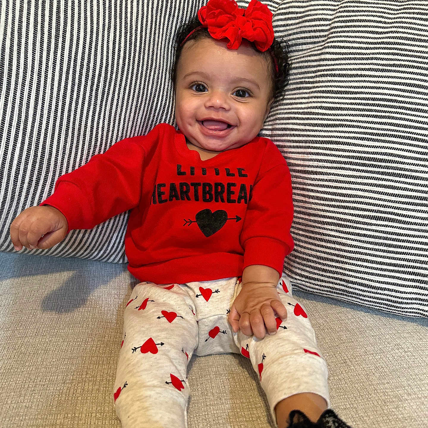 Harper joined the competition — help win amazing prizes! baby, bodypart, clothing, couch, cushion, face, finger, footwear, furniture, happy, head, homedecor, hosiery, pants, person, photography, portrait, shoe, sitting, sock