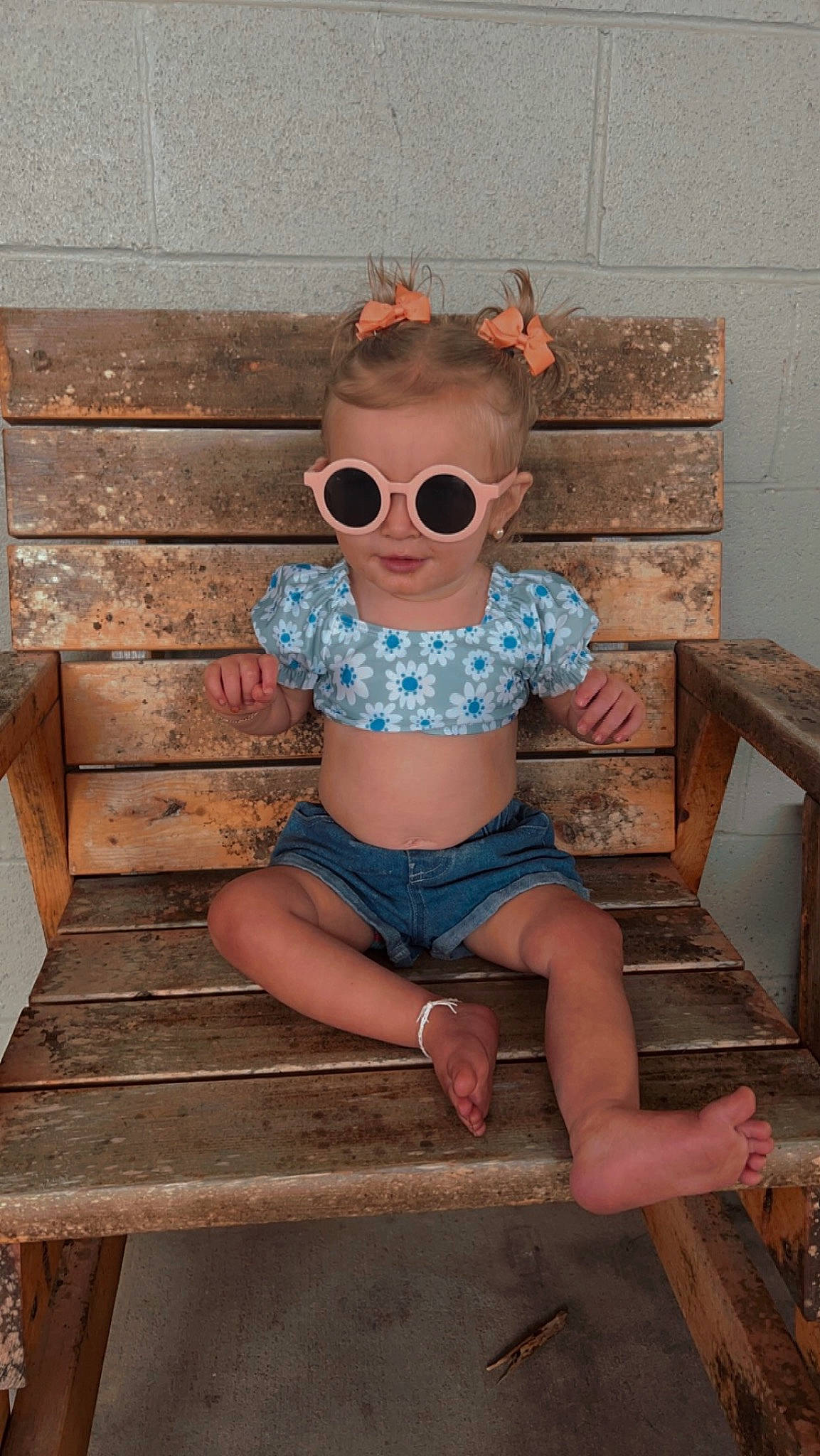 Sofia joined the competition — help win amazing prizes! baby_toddler_clothing, brick, eyewear, fun, glasses, goggles, human_leg, leisure, neck, outdoor_furniture, person, personal_protective_equipment, pink, shorts, sitting, sunglasses, t_shirt, thigh, vision_care, waist