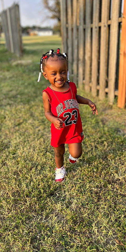 Ar'Mani is registered to the contest to win money with this photo: baby, baby_toddler_clothing, eye, face, grass, hair, hand, happy, hat, head, joy, leg, leisure, people_in_nature, person, plant, recreation, shorts, smile, soccer_ball