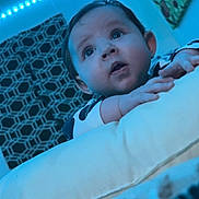 Everleigh joined the competition — help win amazing prizes! baby, infant, face, blue_light, led_lights, cushion, blanket, indoor, child, eyes, hands, pattern, wall_art, nursery, person, portrait, sleepwear, expression, curious, head