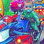 baby, child, carnival, ride, motorcycle, colorful, lights, pacifier, green_tracksuit, adidas, hand, toy, amusement_park, night, fun, person, footwear, helmet, seat, play