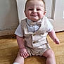 Caleb is registered to the contest to win money with this photo: baby, bow_tie, child, clothing, cute, door, floor, happy, indoor, infant, person, portrait, shoes, shorts, sitting, smiling, socks, vest, white_shirt, wooden_floor