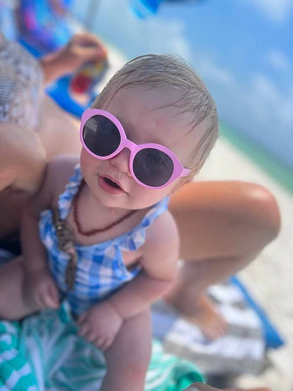 Emmalyn joined the competition — help win amazing prizes! azure, baby, blue, child, cool, eyewear, facial_expression, fun, goggles, grass, happy, hat, headgear, leisure, ocean, person, personal_protective_equipment, recreation, sunglasses, toddler
