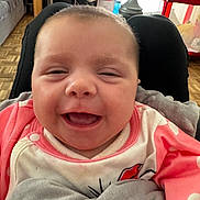Juliana participe au concours pour gagner de l'argent avec cette photo : baby, smiling, indoor, blanket, pink_clothing, happy, face, infant, cute, child, cozy, home, furniture, toy, floor, person, portrait, closeup, expression, soft