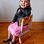 Maryam a rejoint le concours — aidez-le/la à gagner de superbes lots ! black_shoes, casual_clothing, chair, child, curly_hair, cute, fashion, girl, happy, home, indoor, leather_jacket, person, pink_skirt, playful, portrait, sitting, smiling, wooden_floor, young_child