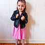 Maryam participe au concours pour gagner de l'argent avec cette photo : black_shoes, child, confident, cute, fashion, fists_up, floor, girl, hair, indoor, leather_jacket, person, pink_dress, portrait, shadow, smile, standing, white_wall, wooden_floor, young