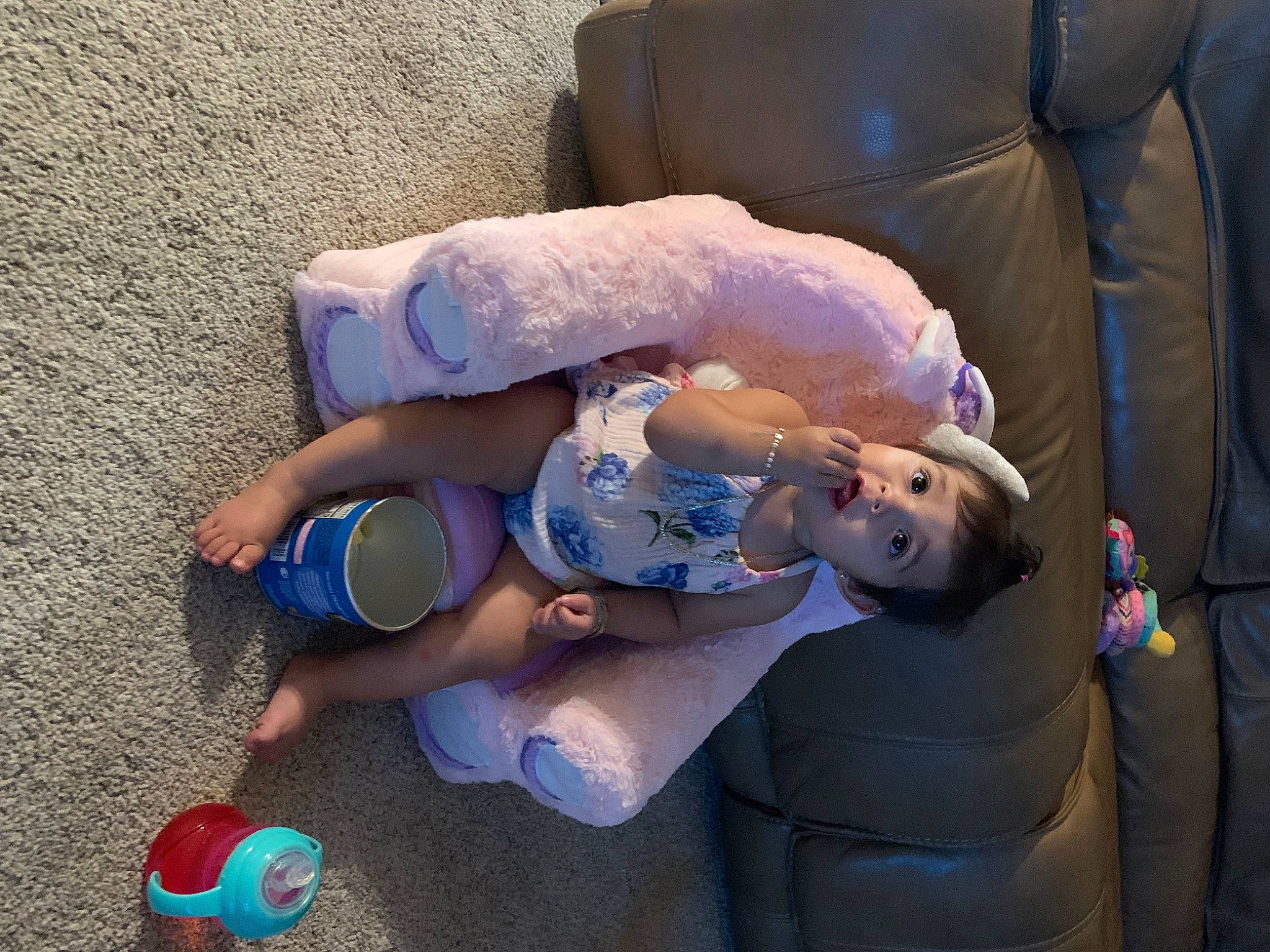 Alaia is registered to the contest to win money with this photo: baby, baby_products, baby_toddler_clothing, child, comfort, couch, electric_blue, foot, fun, hat, human_leg, lap, person, plastic, sitting, surprise, toddler