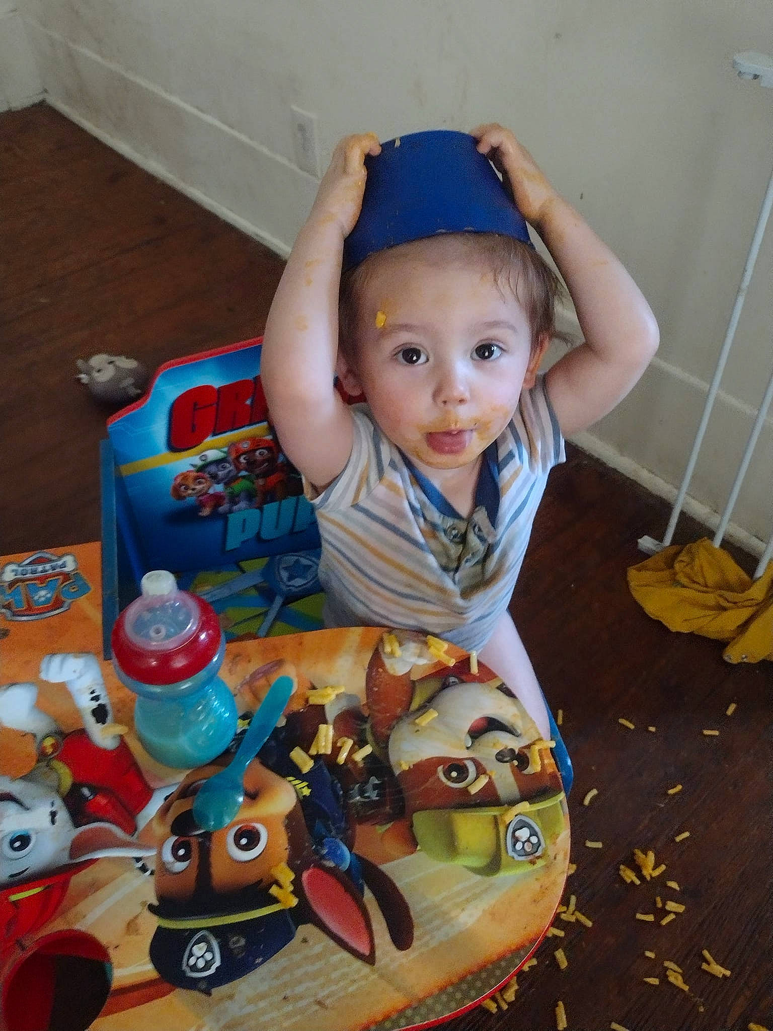 James is registered to the contest to win money with this photo: baby, baby_products, baby_toddler_clothing, baby_toys, chair, child, comfort_food, drinkware, flooring, fun, happy, party, person, plastic, play, room, sitting, smile, textile, toddler