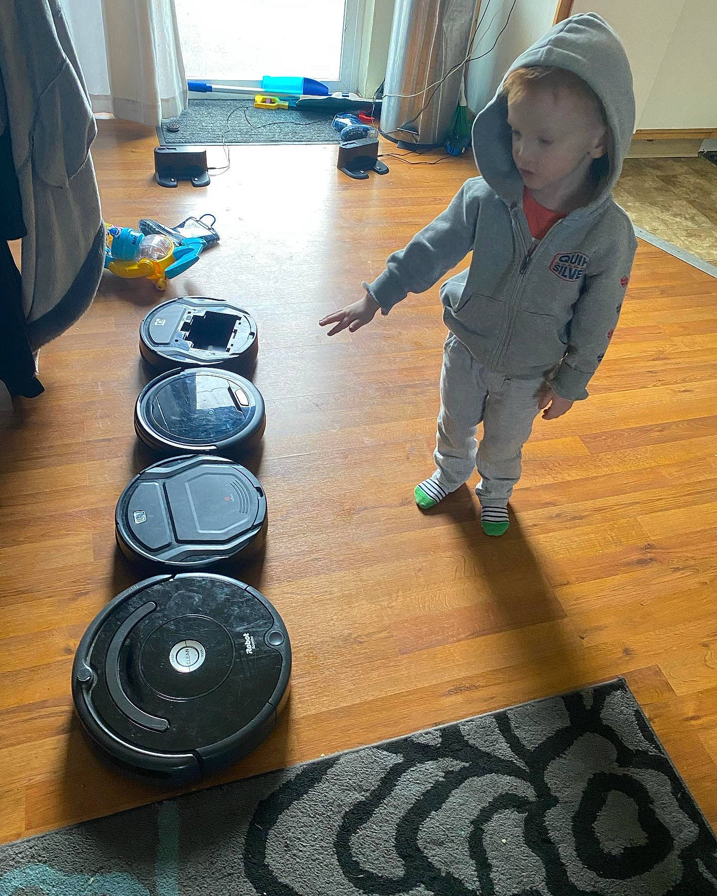 Atreyu is registered to the contest to win money with this photo: audio_equipment, automotive_tire, child, circle, design, floor, flooring, font, gadget, hardwood, laminate_flooring, person, room, standing, toddler, varnish, white, wood, wood_flooring, wood_stain