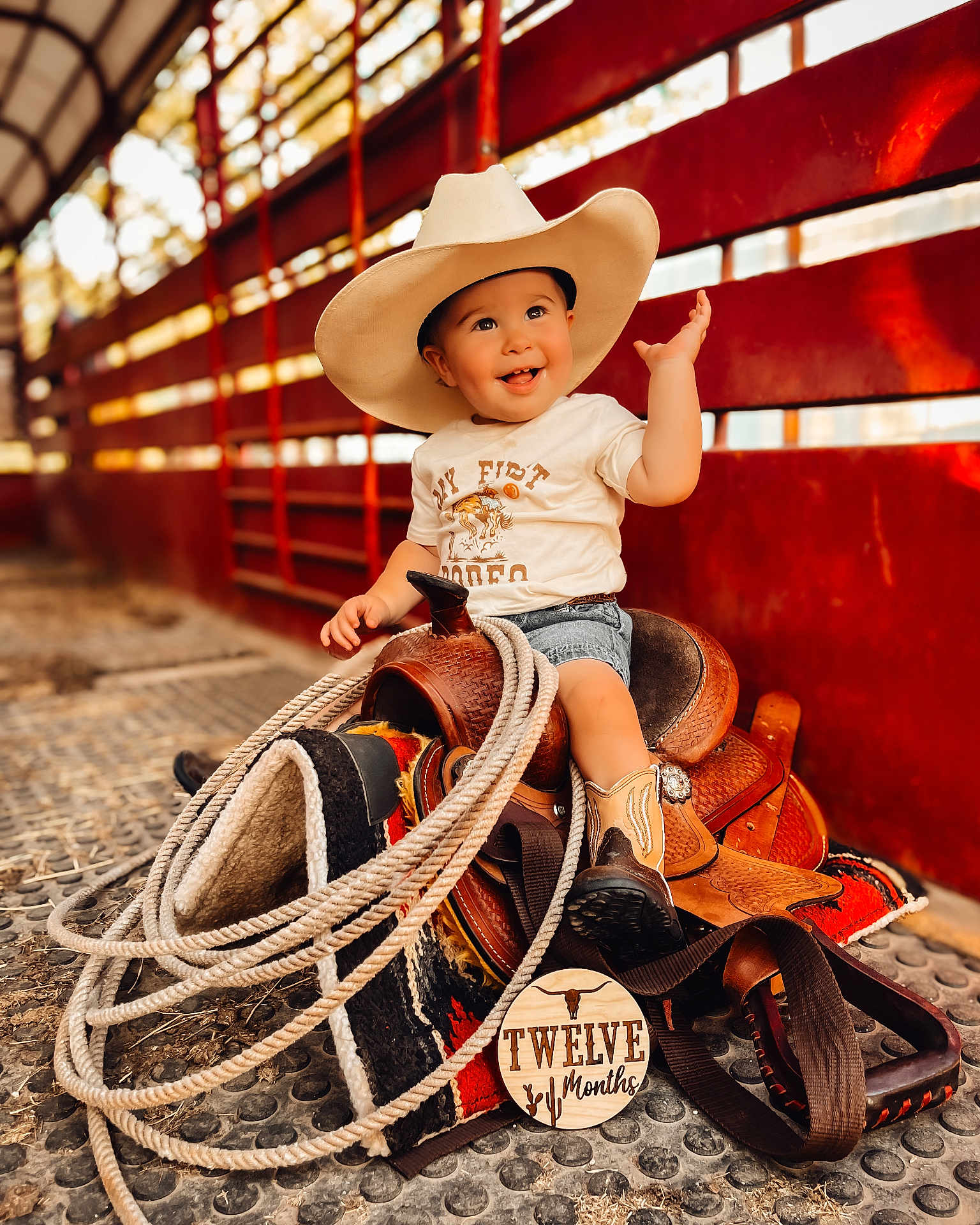 Jace joined the competition — help win amazing prizes! baby, beachwear, clothing, costume, cowboyhat, face, footwear, hat, head, pants, person, photography, portrait, rodeo, rope, saddle, shoe, shorts, sitting, sunhat