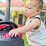 Waylon joined the competition — help win amazing prizes! baby, child, closeup, curious, cute, daylight, exploration, focus, garden, greenery, outdoor, person, play, red, steering_wheel, striped_clothing, summer, toddler, toy_car, young_child