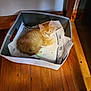 basket, cat, container, cord, cozy, curious, cute, domestic_animal, fluffy, furniture, indoor, kitten, looking, orange_cat, papers, pet, resting, small_animal, wooden_floor, young_cat