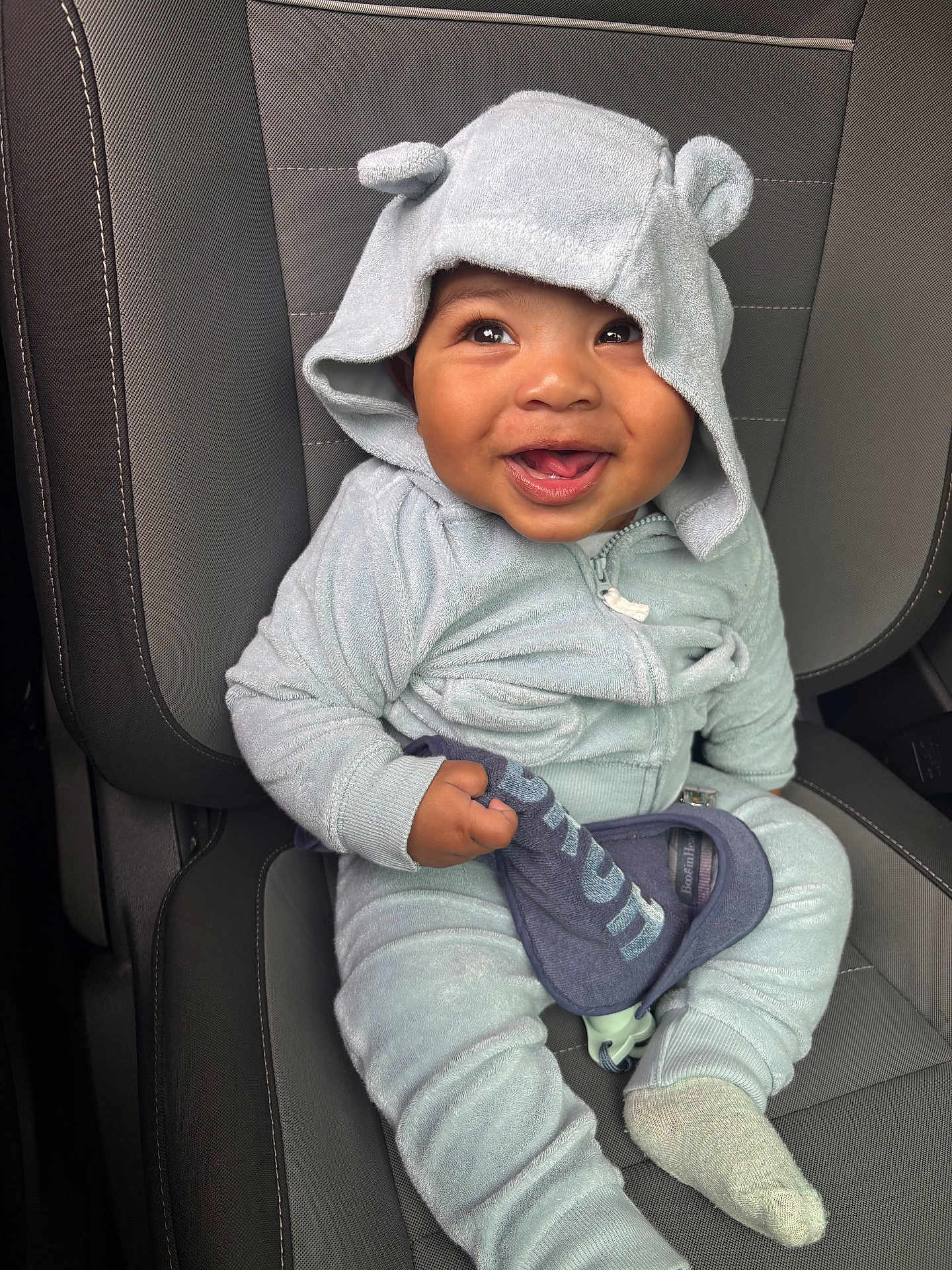Romeo joined the competition — help win amazing prizes! baby, bib, blue_clothing, car_seat, child, clothing, cute, eyes, face, footwear, hands, happy, hooded_outfit, indoor, infant, portrait, seatbelt, sitting, smiling, sock