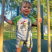 Olliemore joined the competition — help win amazing prizes! toddler, child, playground, outdoor, park, trees, sunlight, clothing, shorts, shirt, sneakers, smile, happy, play, summer, daytime, person, metal_bars, greenery, fun
