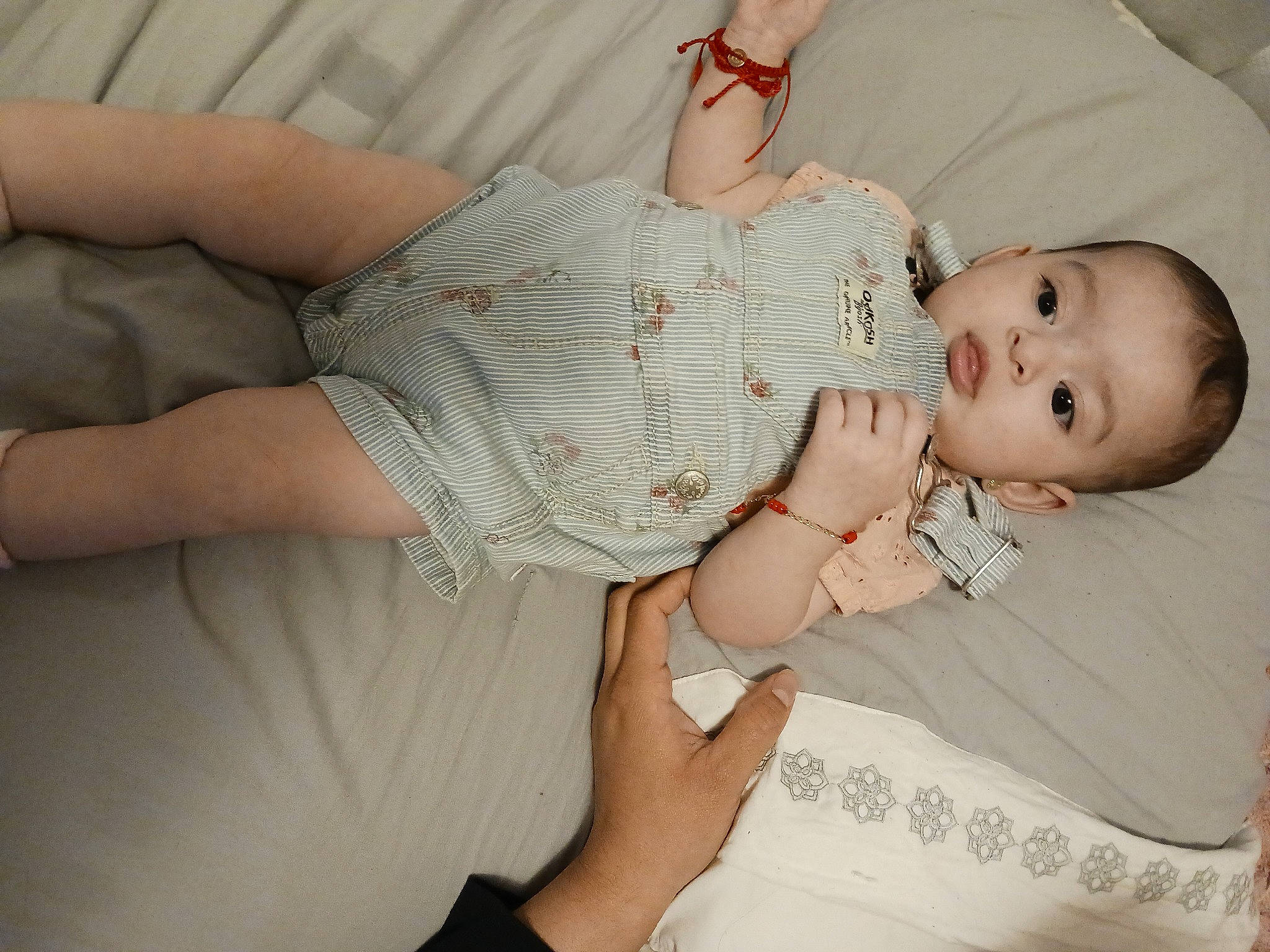 Itzel is registered to the contest to win money with this photo: arm, baby, baby_toddler_clothing, cheek, child, comfort, dress, elbow, finger, gesture, hand, happy, lip, mouth, nail, pattern, person, skin, sleeve, thigh