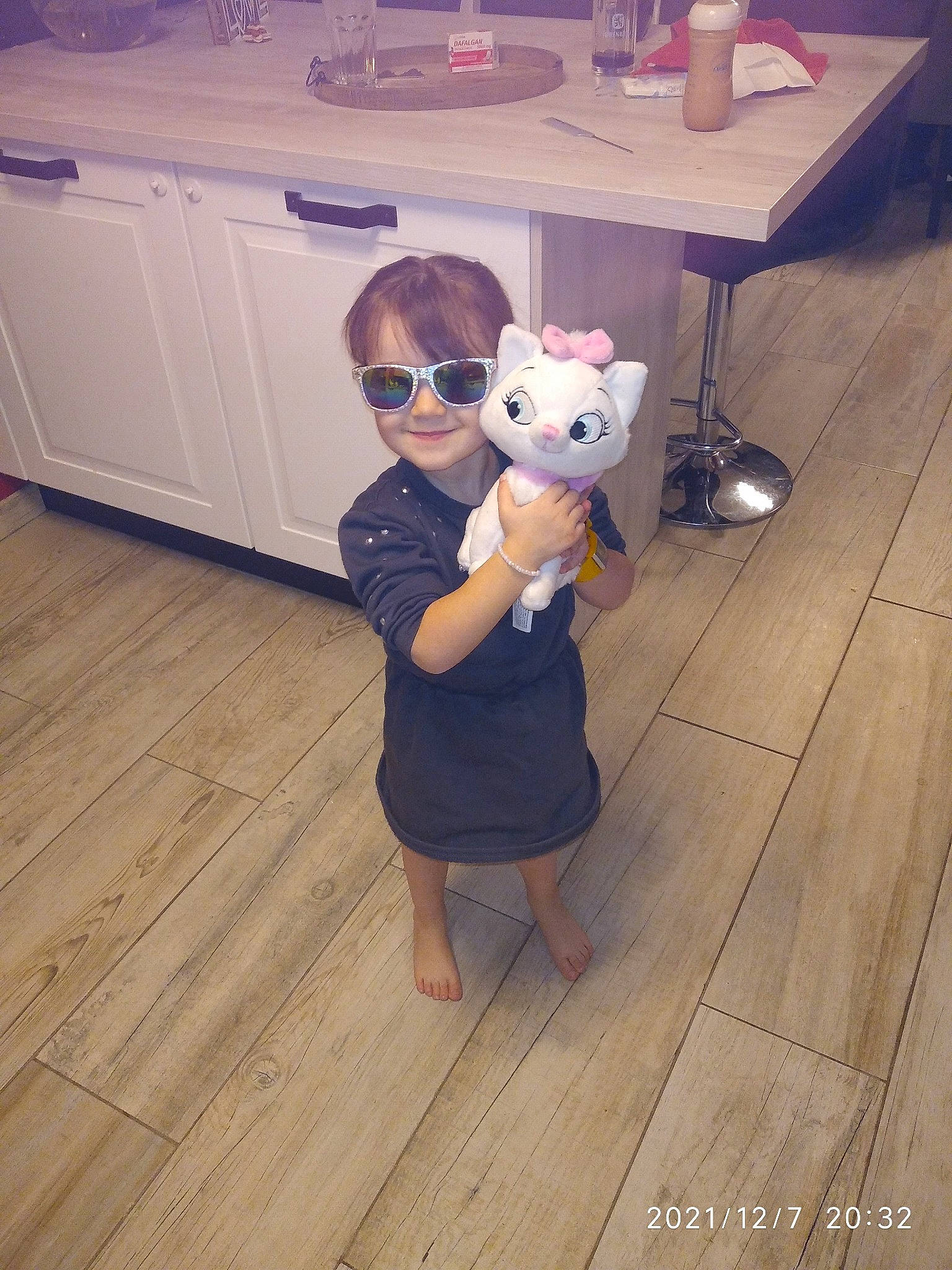 Lily participe au concours pour gagner de l'argent avec cette photo : companion_dog, eyewear, fawn, floor, flooring, fun, fur, happy, hardwood, joy, laminate_flooring, person, plank, room, sunglasses, tableware, toddler, toy, varnish, wood