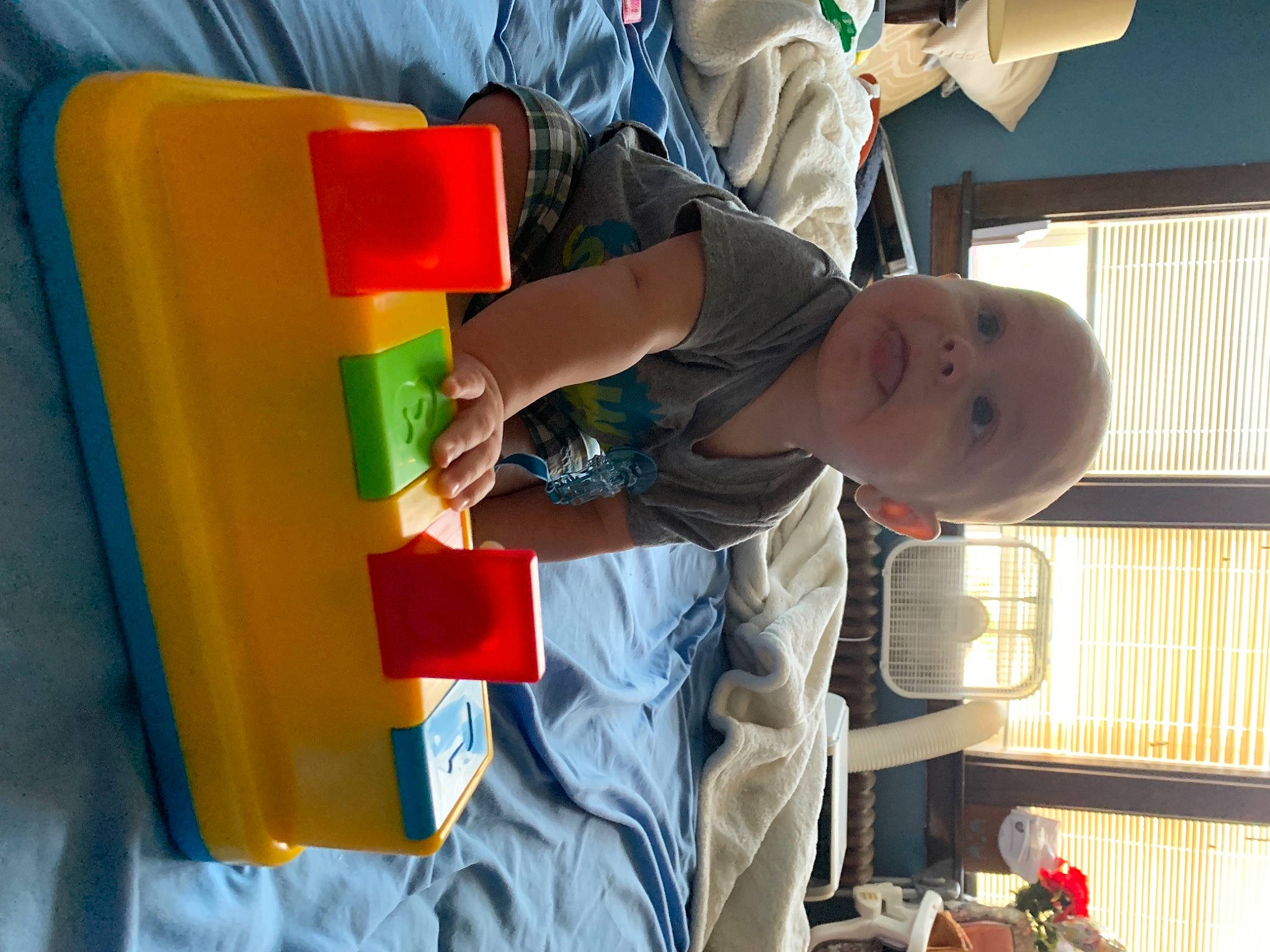 Decklyn is registered to the contest to win money with this photo: child, electric_blue, fun, hat, leisure, paint, person, plastic, play, recreation, room, t_shirt, toddler, window_blind