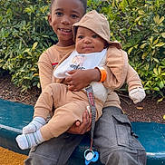 Bentley joined the competition — help win amazing prizes! child, baby, siblings, outdoor, bench, greenery, smiling, cute, hood, casual_clothing, baby_bib, pacifier, happy, nature, candid, park, holding, portrait, people, family